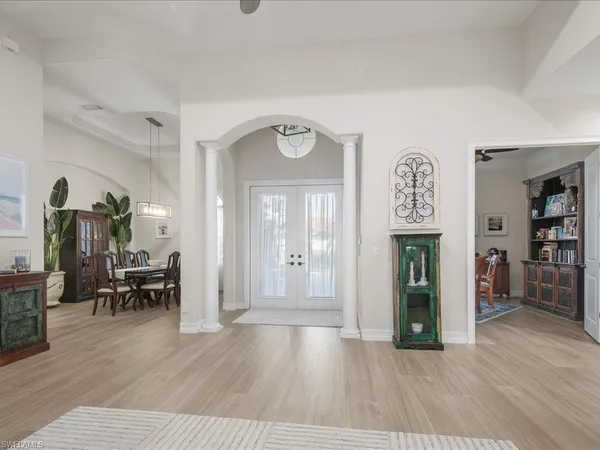 a view of a room with furniture and wooden floor