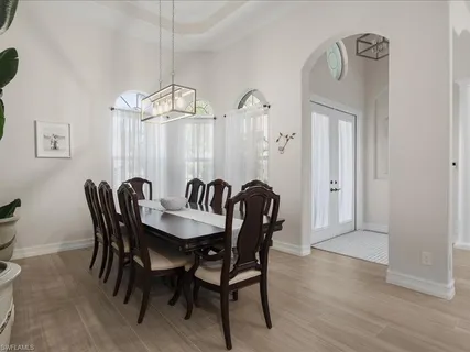 a view of a dining room with furniture wooden floor and a chandelier