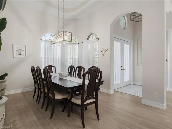 a view of a dining room with furniture wooden floor and a chandelier