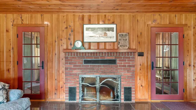 a living room with furniture gym equipment and a large window