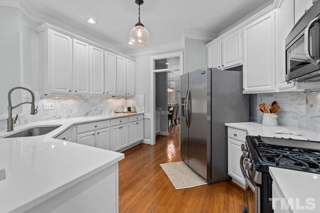 10400 Old Warden Road Raleigh, NC 27615 - Photo 11 of 30 a kitchen with stainless steel appliances a refrigerator sink and cabinets