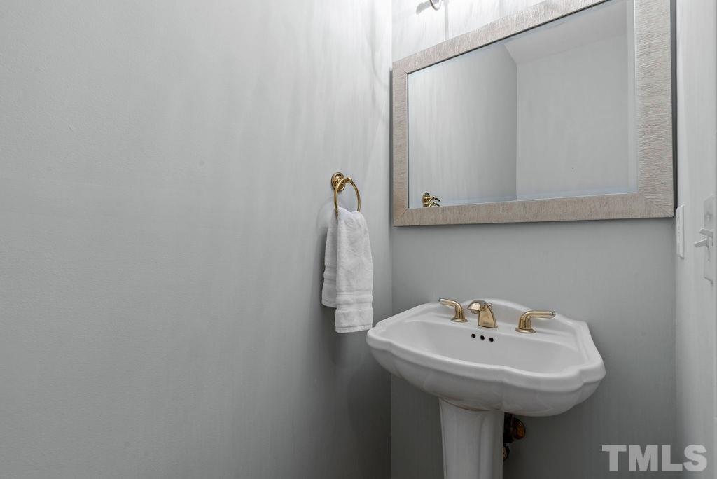 10400 Old Warden Road Raleigh, NC 27615 - Photo 13 of 30 a sink and a mirror