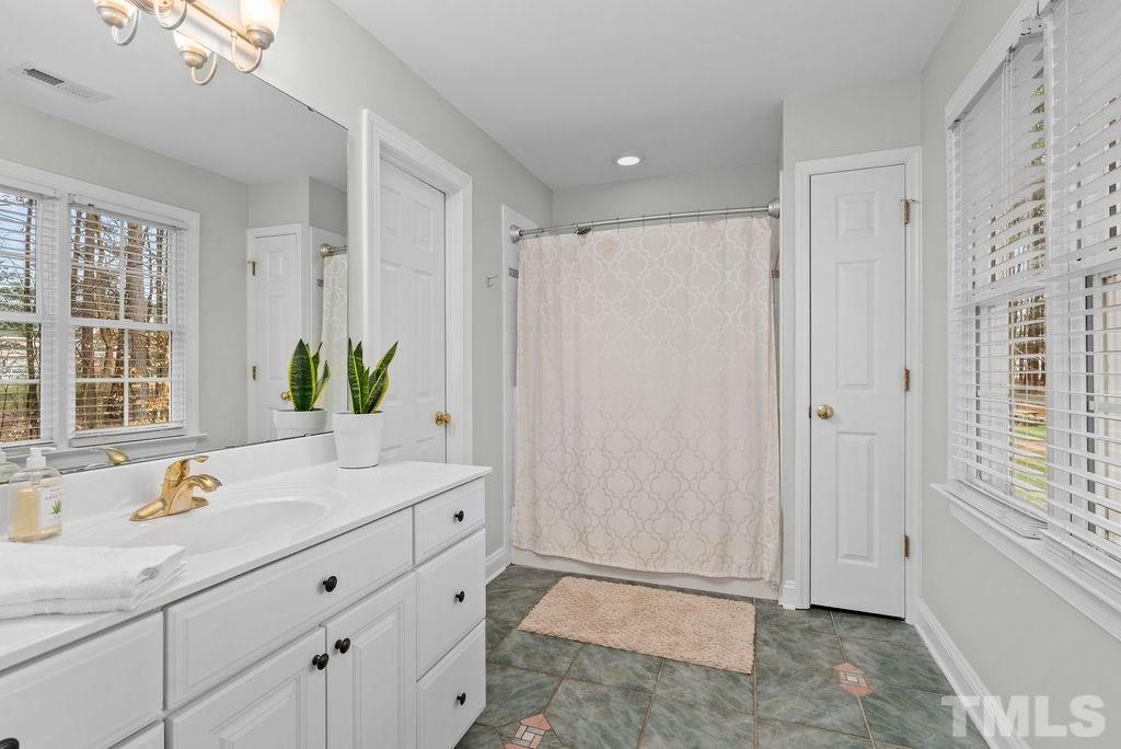 10400 Old Warden Road Raleigh, NC 27615 - Photo 16 of 30 a bathroom with a granite countertop sink and a mirror