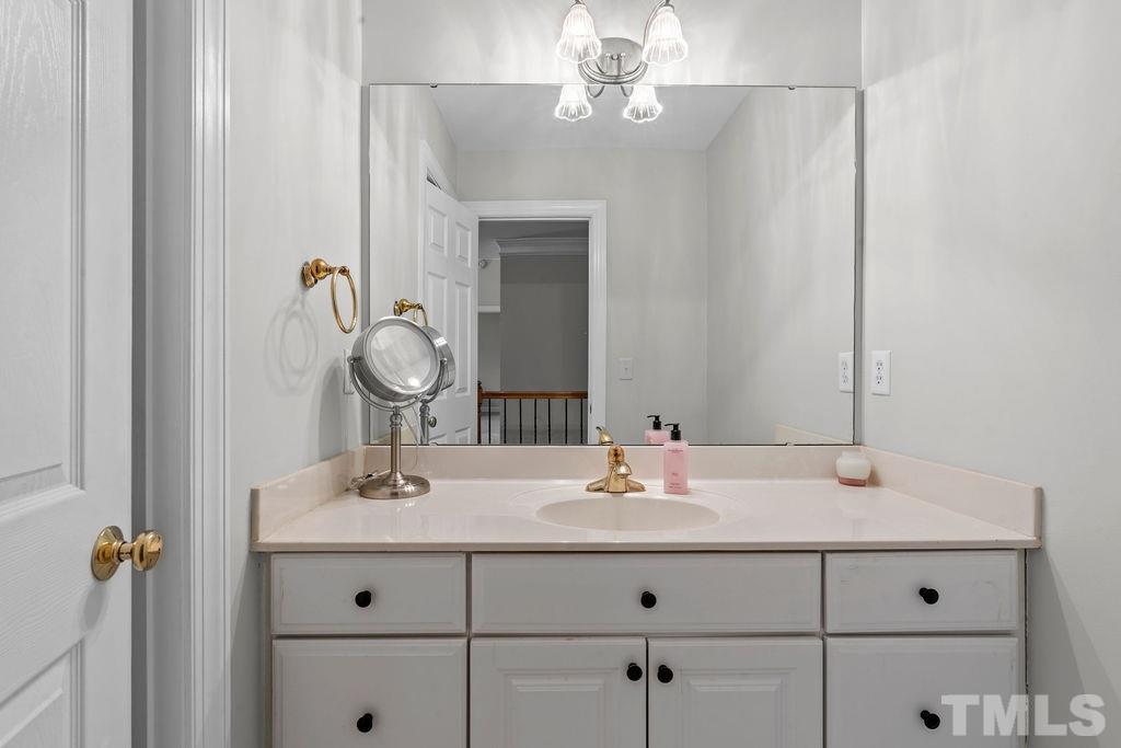 10400 Old Warden Road Raleigh, NC 27615 - Photo 18 of 30 a bathroom with a sink and a mirror