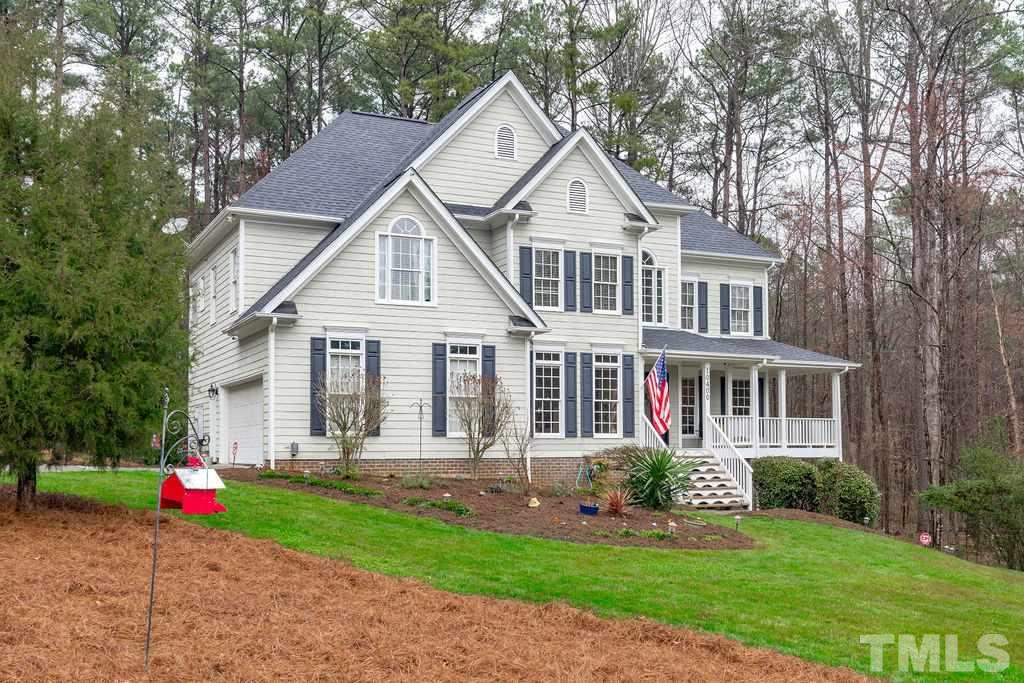 10400 Old Warden Road Raleigh, NC 27615 - Photo 3 of 30 a front view of a house with a yard and trees