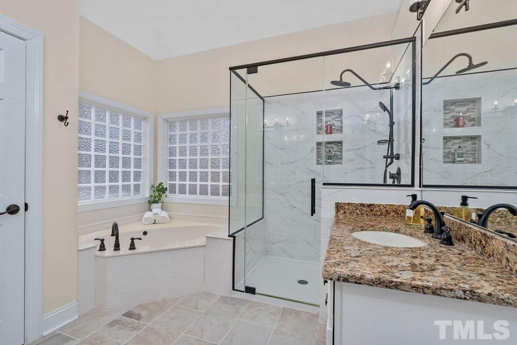 10400 Old Warden Road Raleigh, NC 27615 - Photo 21 of 30 a bathroom with a granite countertop sink and a mirror