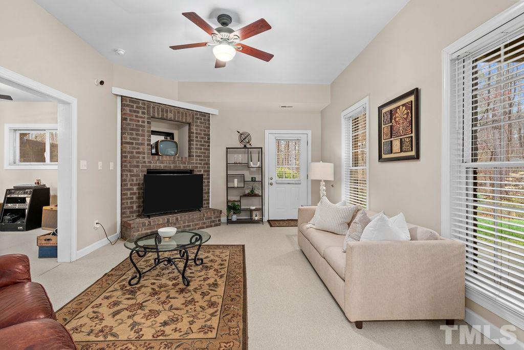 10400 Old Warden Road Raleigh, NC 27615 - Photo 22 of 30 a living room with furniture and a flat screen tv