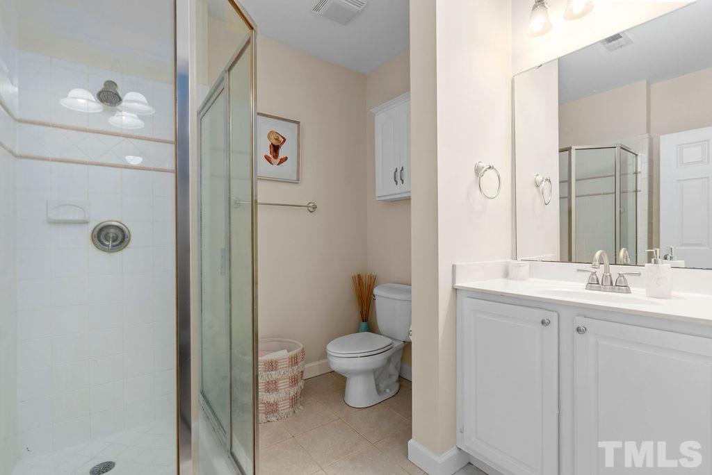 10400 Old Warden Road Raleigh, NC 27615 - Photo 23 of 30 a bathroom with a toilet sink and mirror