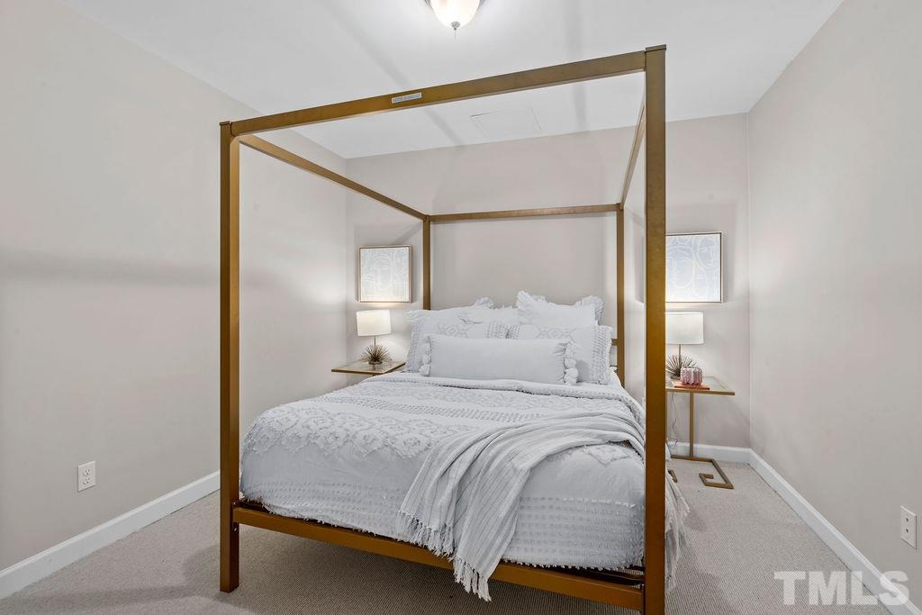 10400 Old Warden Road Raleigh, NC 27615 - Photo 26 of 30 a bedroom with a bed and a mirror