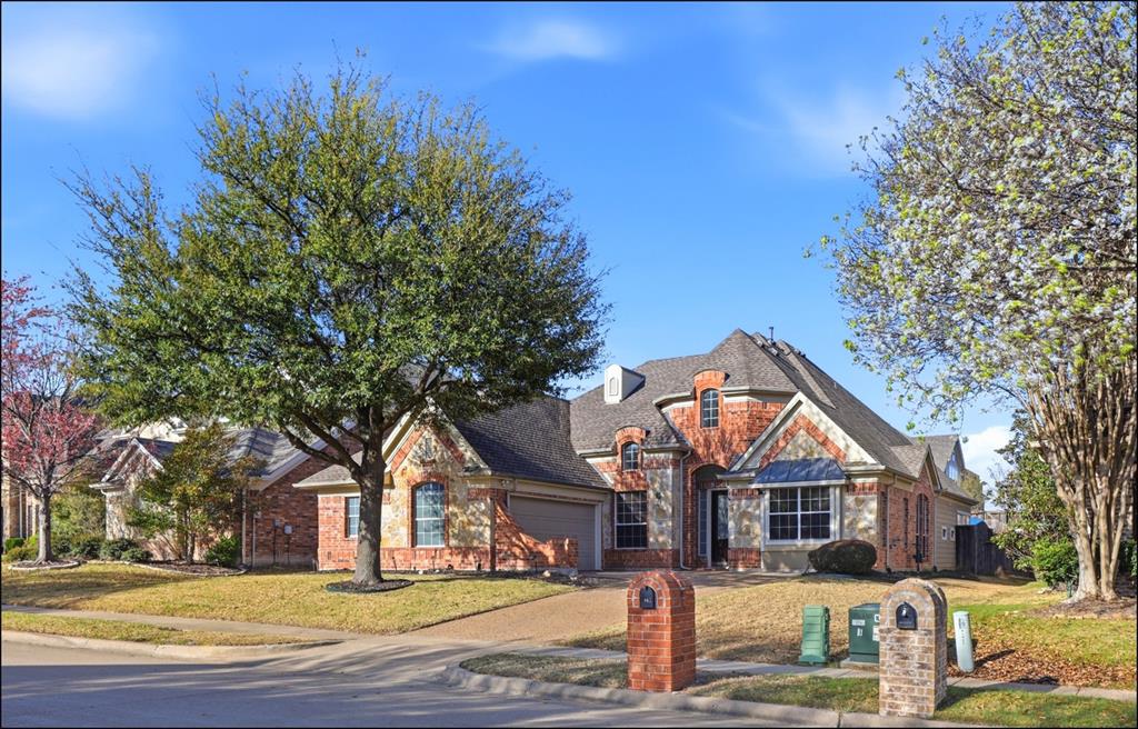 a front view of a house with a tree in it