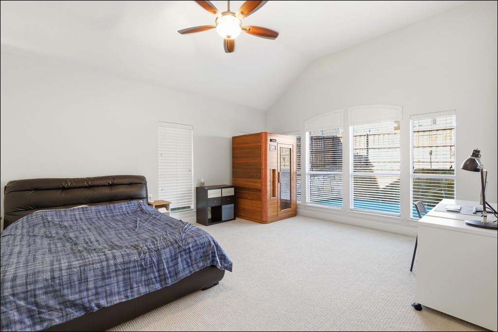 1905 Natchez Trace Allen, TX 75013 - Photo 12 of 26 a bedroom with a large bed and a chandelier