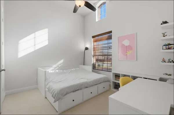 a bedroom with a bed and a window