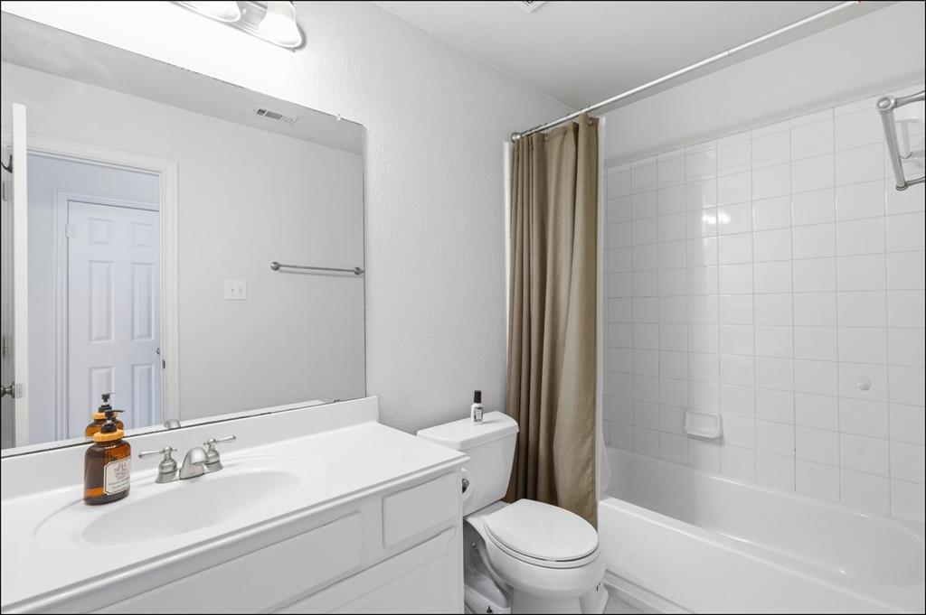 1905 Natchez Trace Allen, TX 75013 - Photo 22 of 26 a bathroom with a sink a toilet and shower