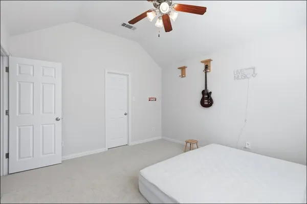 a bedroom with a white bed and a chandelier