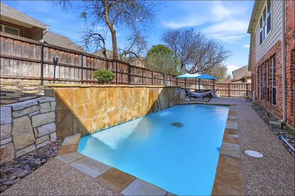 a view of a swimming pool with a patio and couches