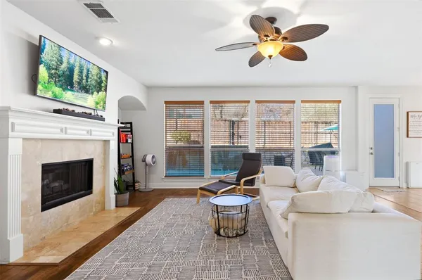 a living room with furniture a fireplace and a flat screen tv