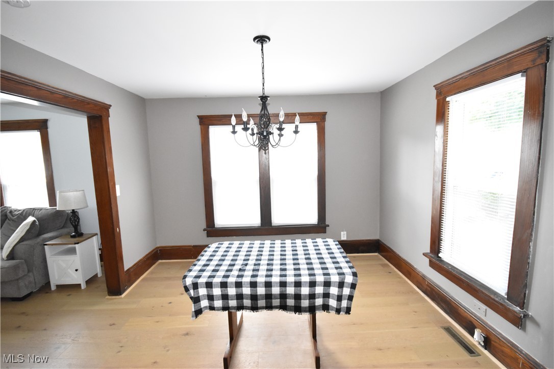 808 West Riddle Avenue Ravenna, OH 44266 - Photo 6 of 28 Dining room featuring light hardwood / wood-style flooring and a chandelier