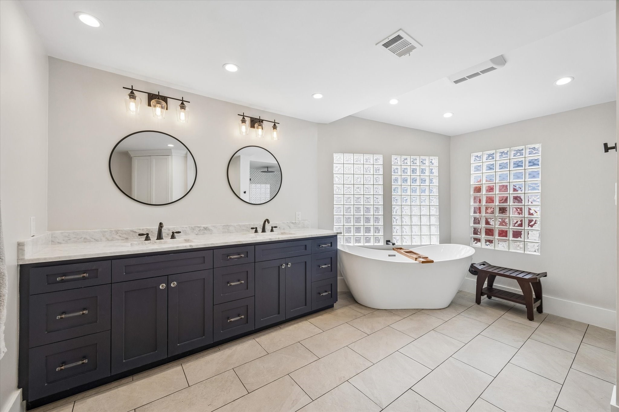 1307 Marshall Street Houston, TX 77006 - Photo 11 of 23 The primary bath is serene and spa like and has access to the primary bedroom and closet.