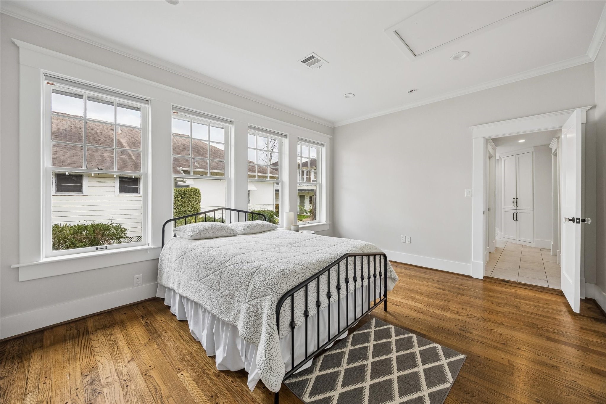 1307 Marshall Street Houston, TX 77006 - Photo 12 of 23 Sun drenched downstairs bedroom has gleaming hardwoods and a bank of windows.