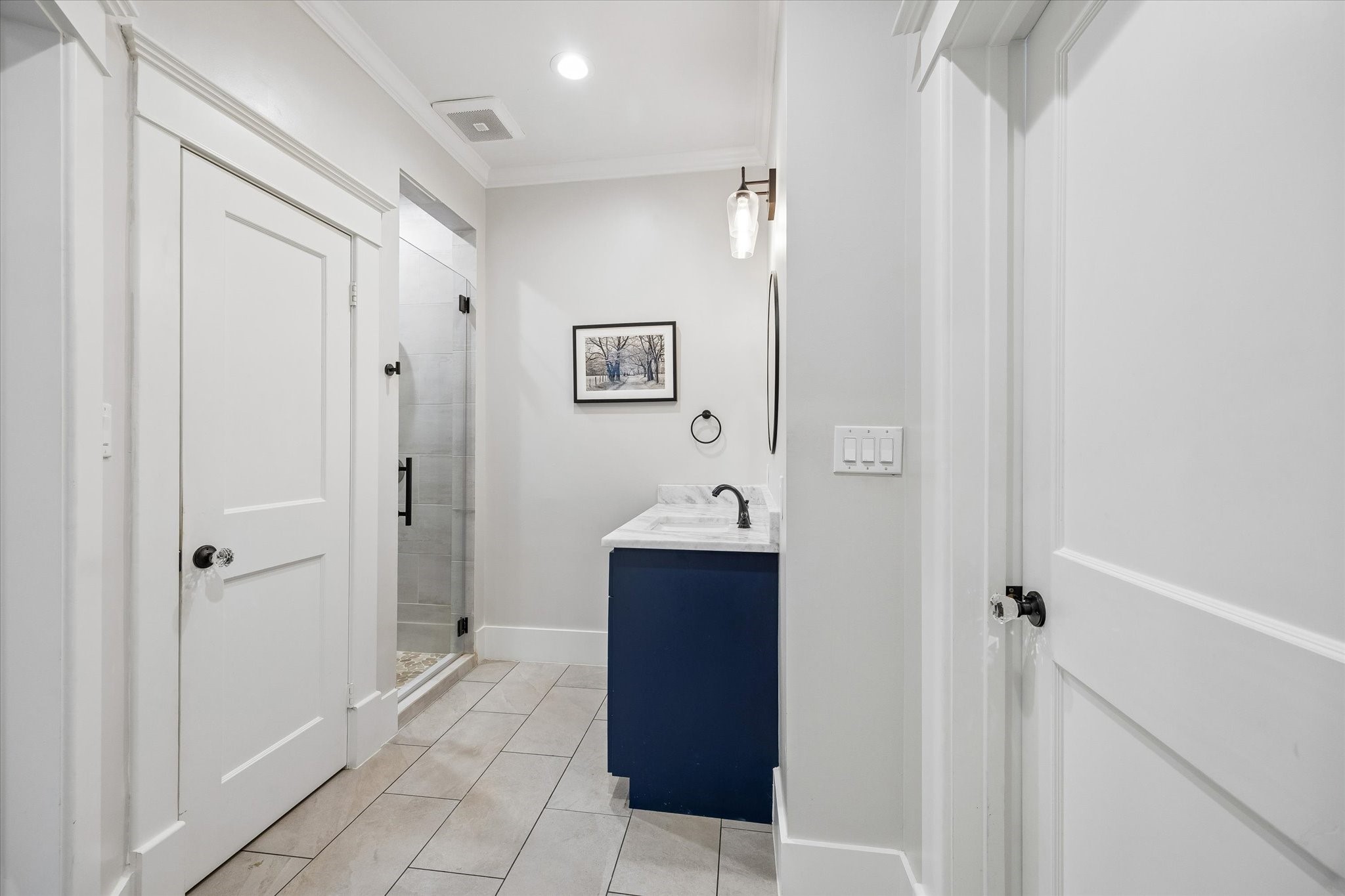 1307 Marshall Street Houston, TX 77006 - Photo 13 of 23 The secondary downstairs bathroom has access to the bedroom and living area, as well as the laundry room.