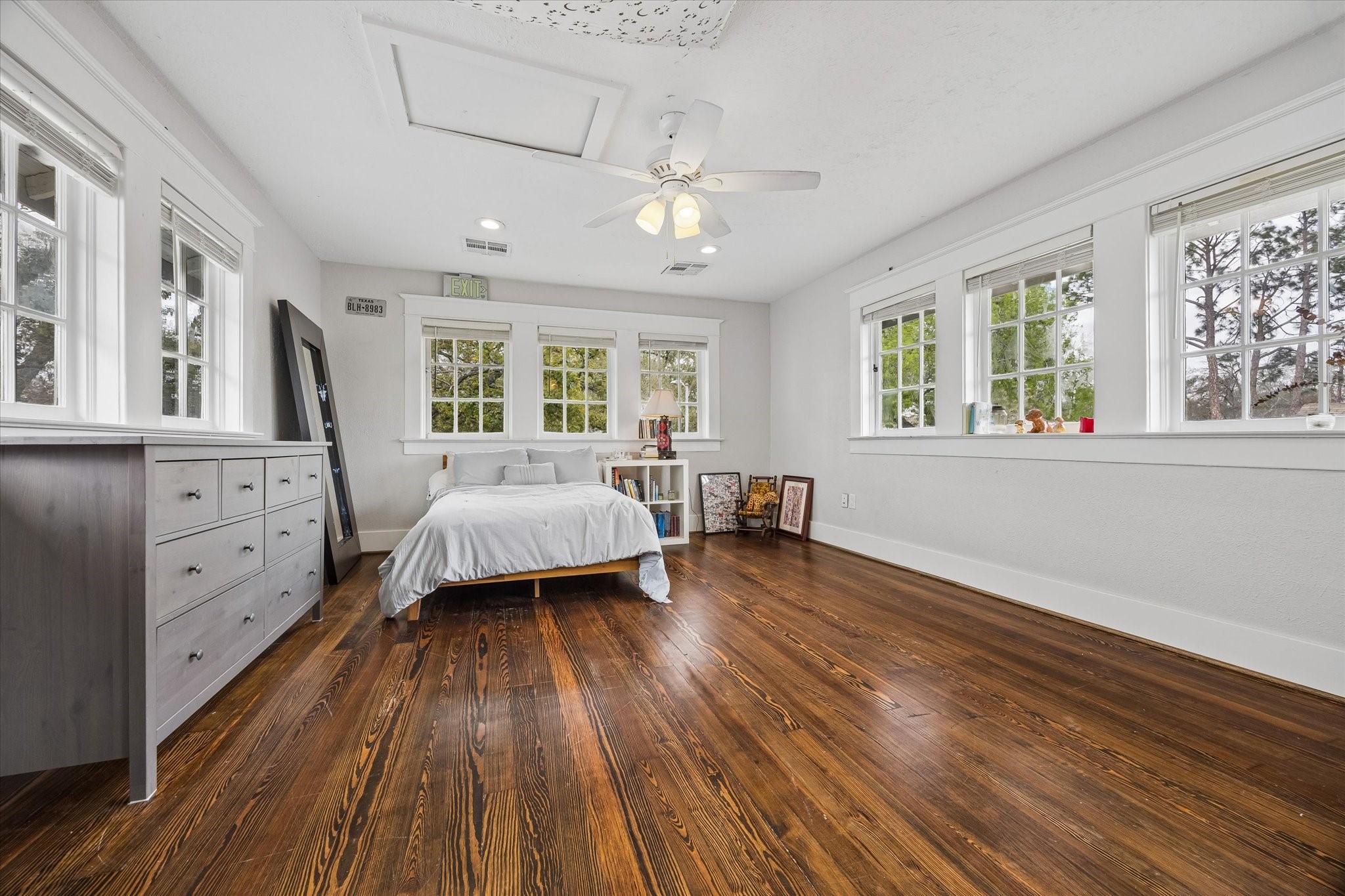1307 Marshall Street Houston, TX 77006 - Photo 14 of 23 Treehouse vibes in the upstairs bedroom with three walls of windows. This bedroom has access to a large walk in closet and a private bathroom with meditation space.