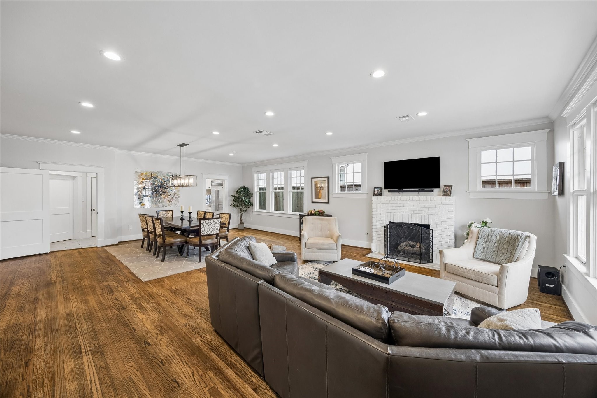1307 Marshall Street Houston, TX 77006 - Photo 2 of 23 Beautiful sun drenched open concept living and dining with gleaming hardwoods and a wood burning fireplace, this is the perfect space to entertain.