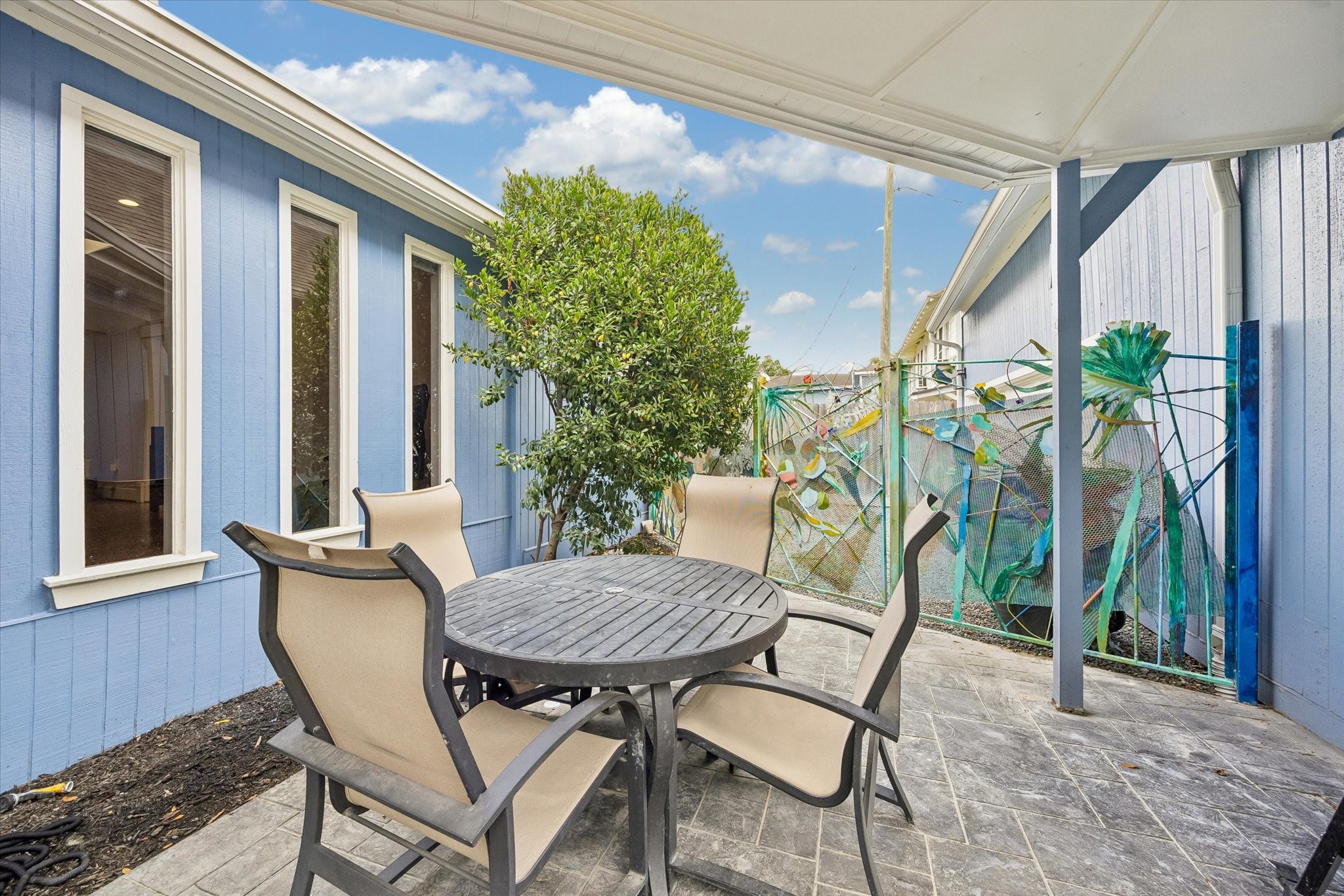 1307 Marshall Street Houston, TX 77006 - Photo 20 of 23 Cozy sitting area by the pool features a fence that is truly a work of art by artist Gertrude Barnstone.
