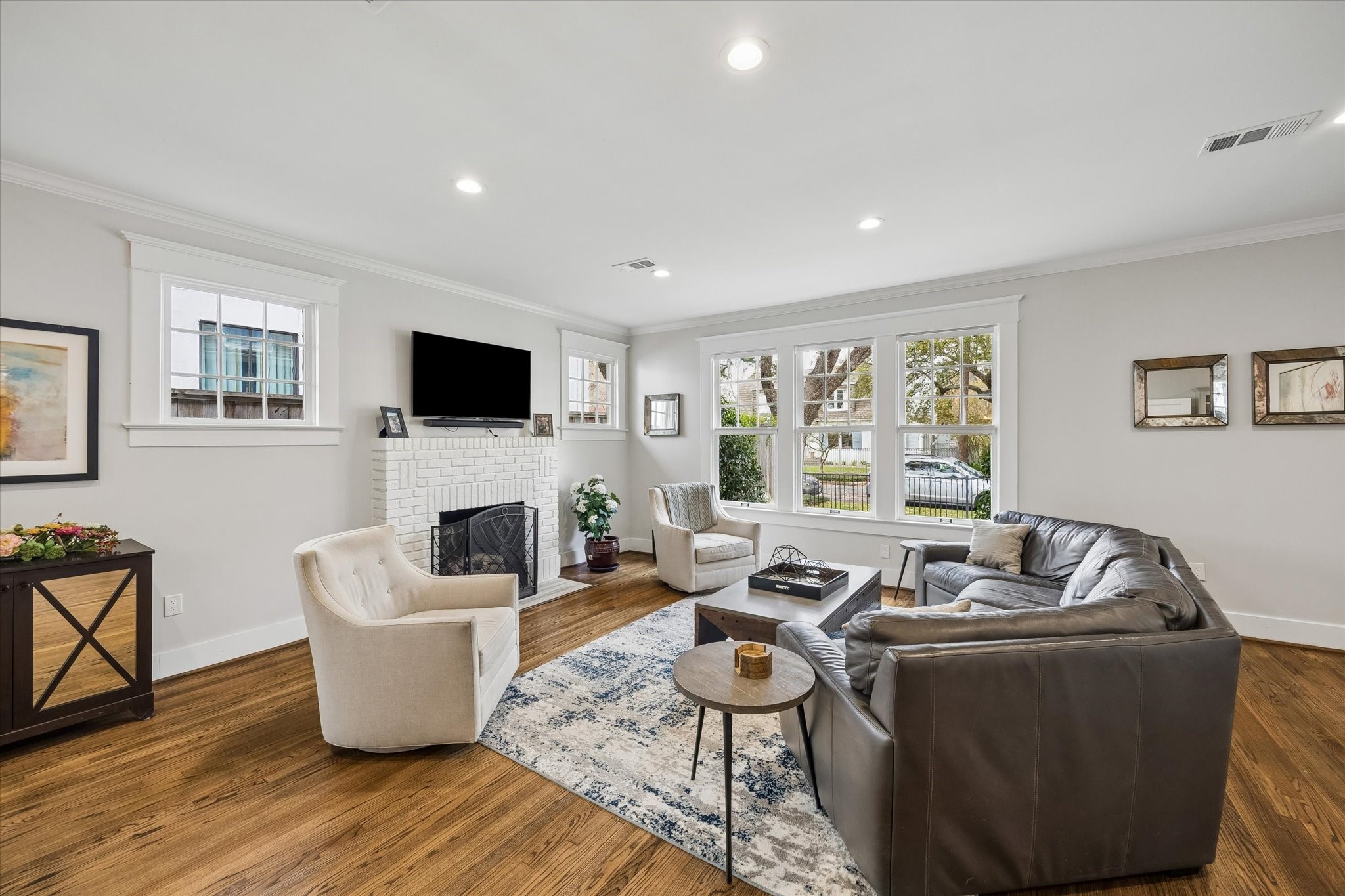 1307 Marshall Street Houston, TX 77006 - Photo 3 of 23 Cozy up around the wood burning fireplace in this light filled family room, open to dining and right off the precious front porch.