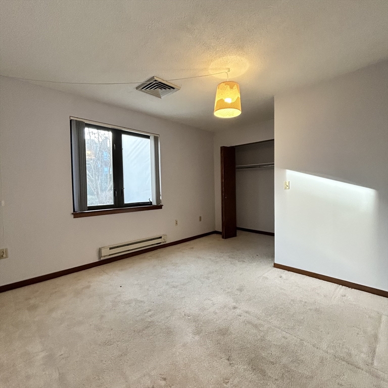 28 Parkman Street, Unit 2 Brookline, MA 02446 - Photo 6 of 11 an empty room with a window and doors