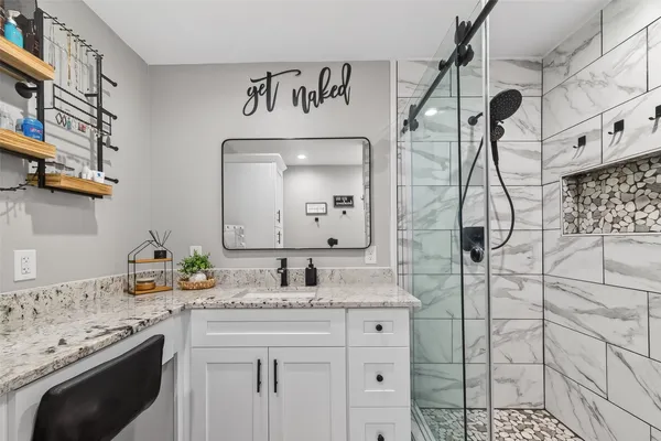 a bathroom with a sink toilet and shower