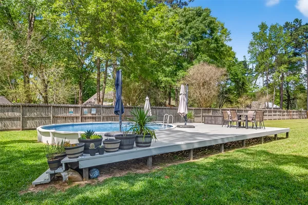 a view of house with backyard and outdoor seating