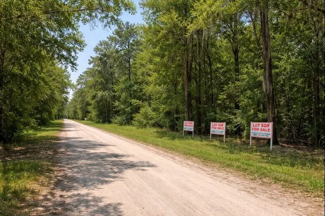 a couple of chairs and a table with wooden fence