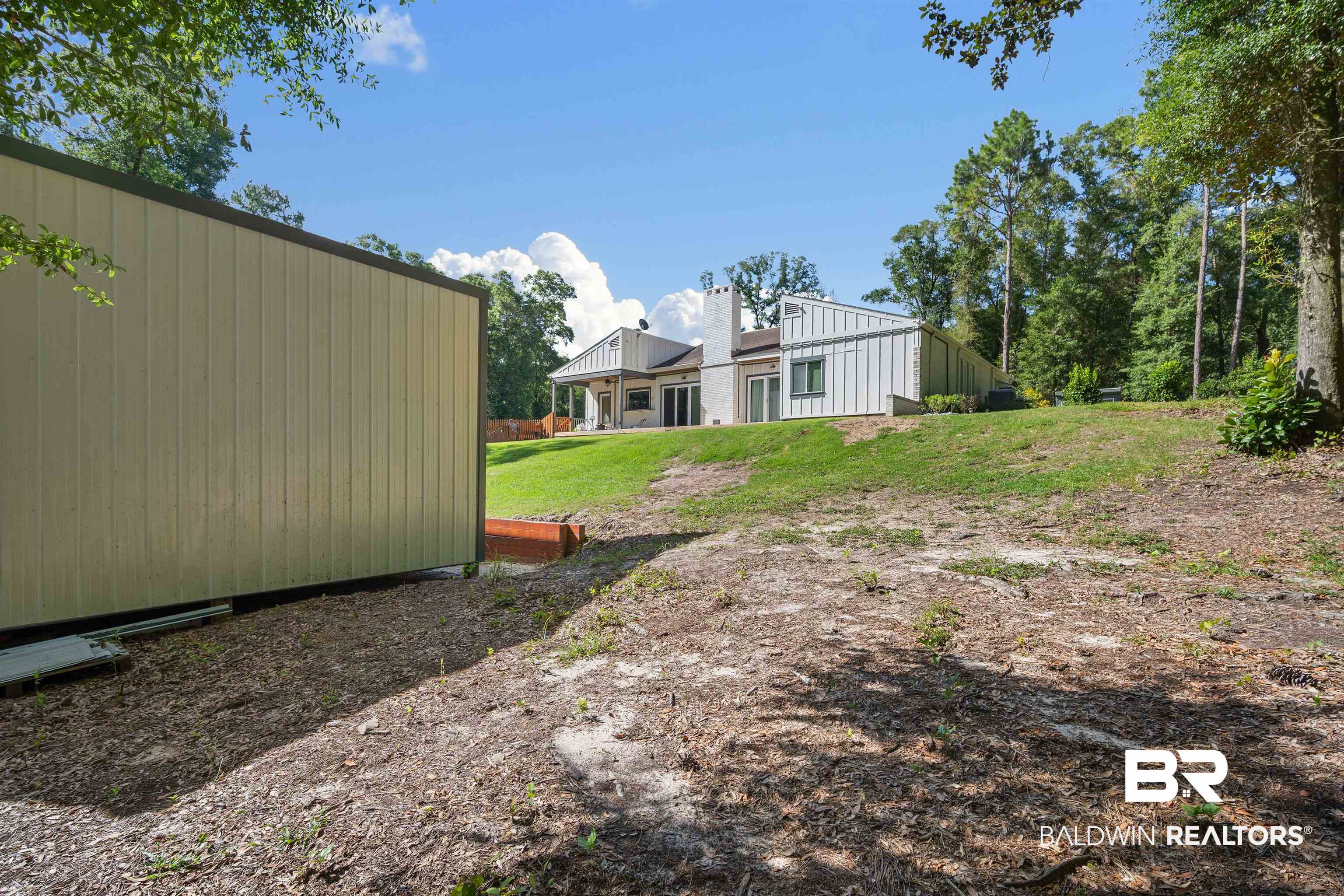 7912 Yorkhaven Road Mobile, AL 36695 - Photo 35 of 41 Rear view of property featuring a patio, a yard, and a chimney