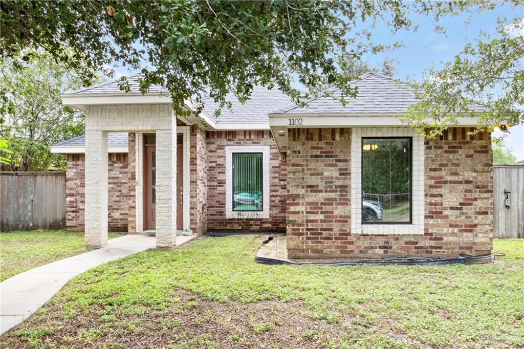 Single story home with a front lawn