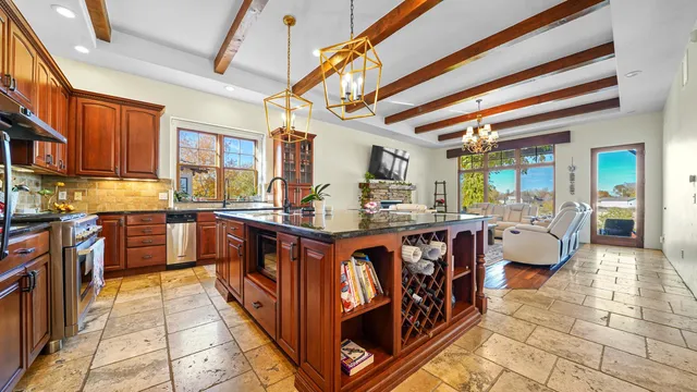 a kitchen with stainless steel appliances granite countertop sink stove top oven and cabinets