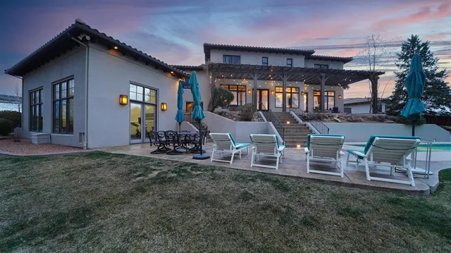 a view of a house with swimming pool and sitting area