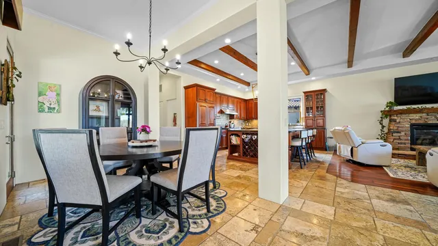 a dining hall with stainless steel appliances a dining table and chairs with wooden floor