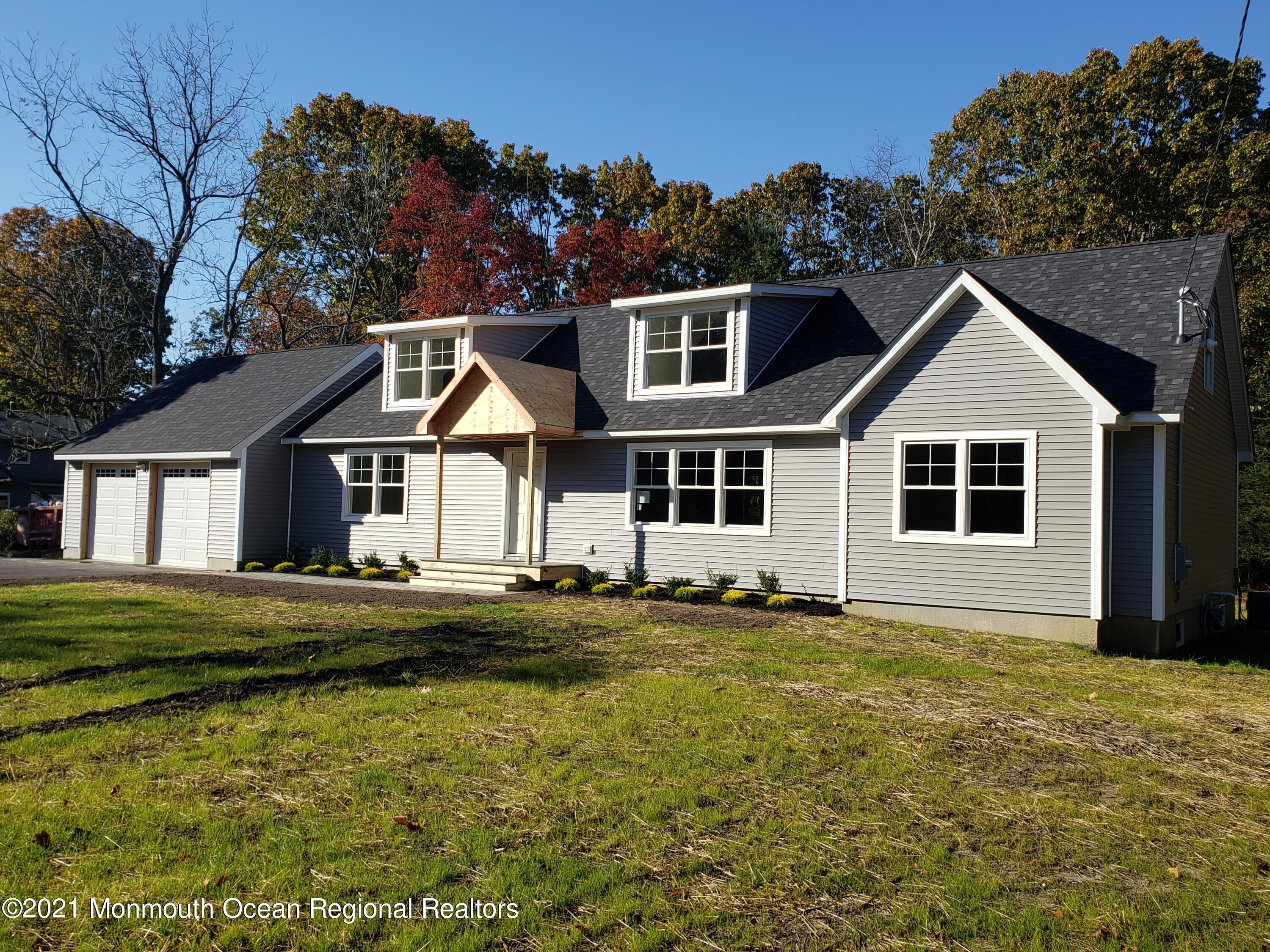 154 Jackson Mills Road Freehold, NJ 07728 - Photo 1 of 19 a front view of a house with a garden