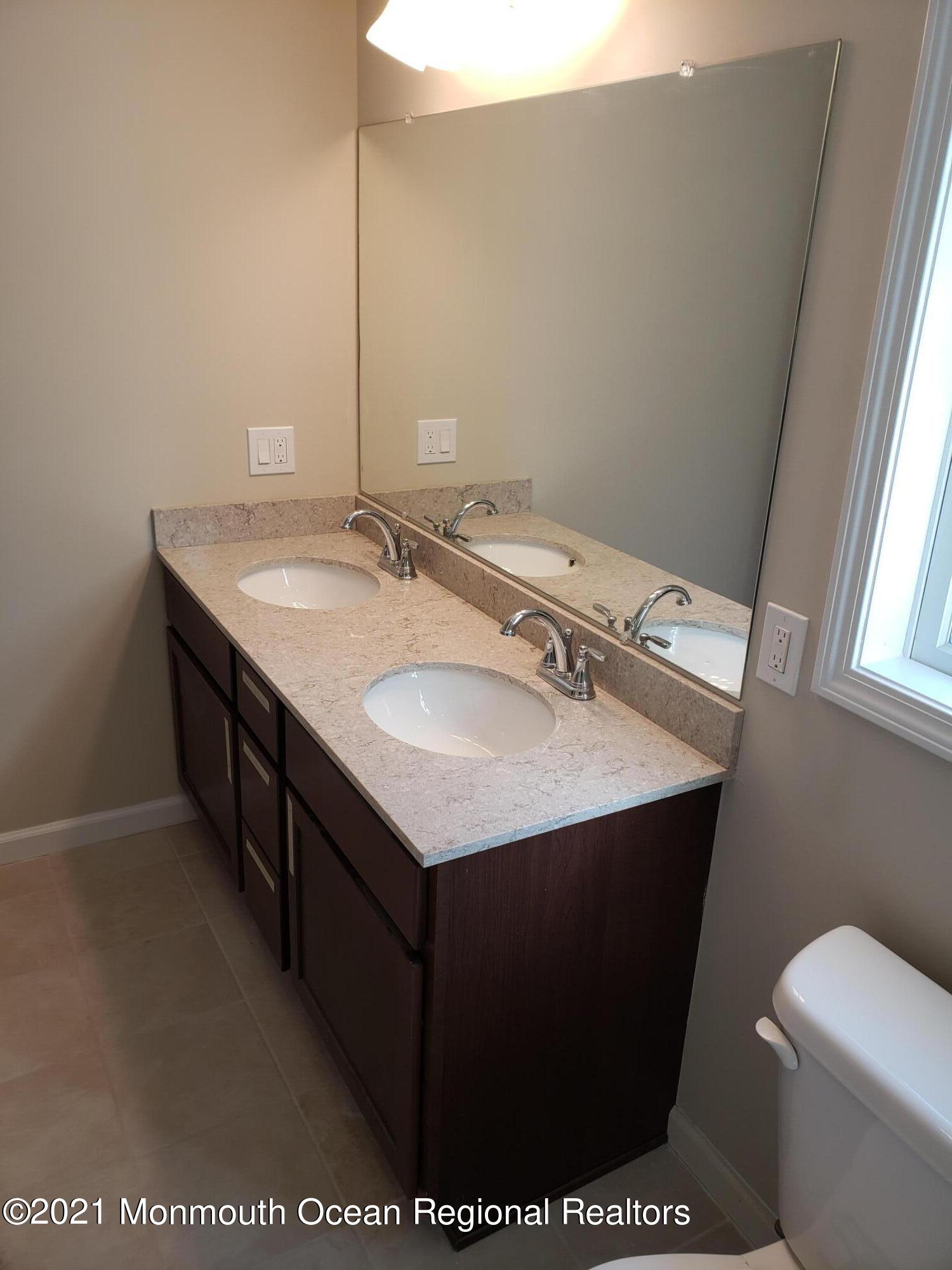 154 Jackson Mills Road Freehold, NJ 07728 - Photo 12 of 19 a bathroom with a sink toilet and mirror