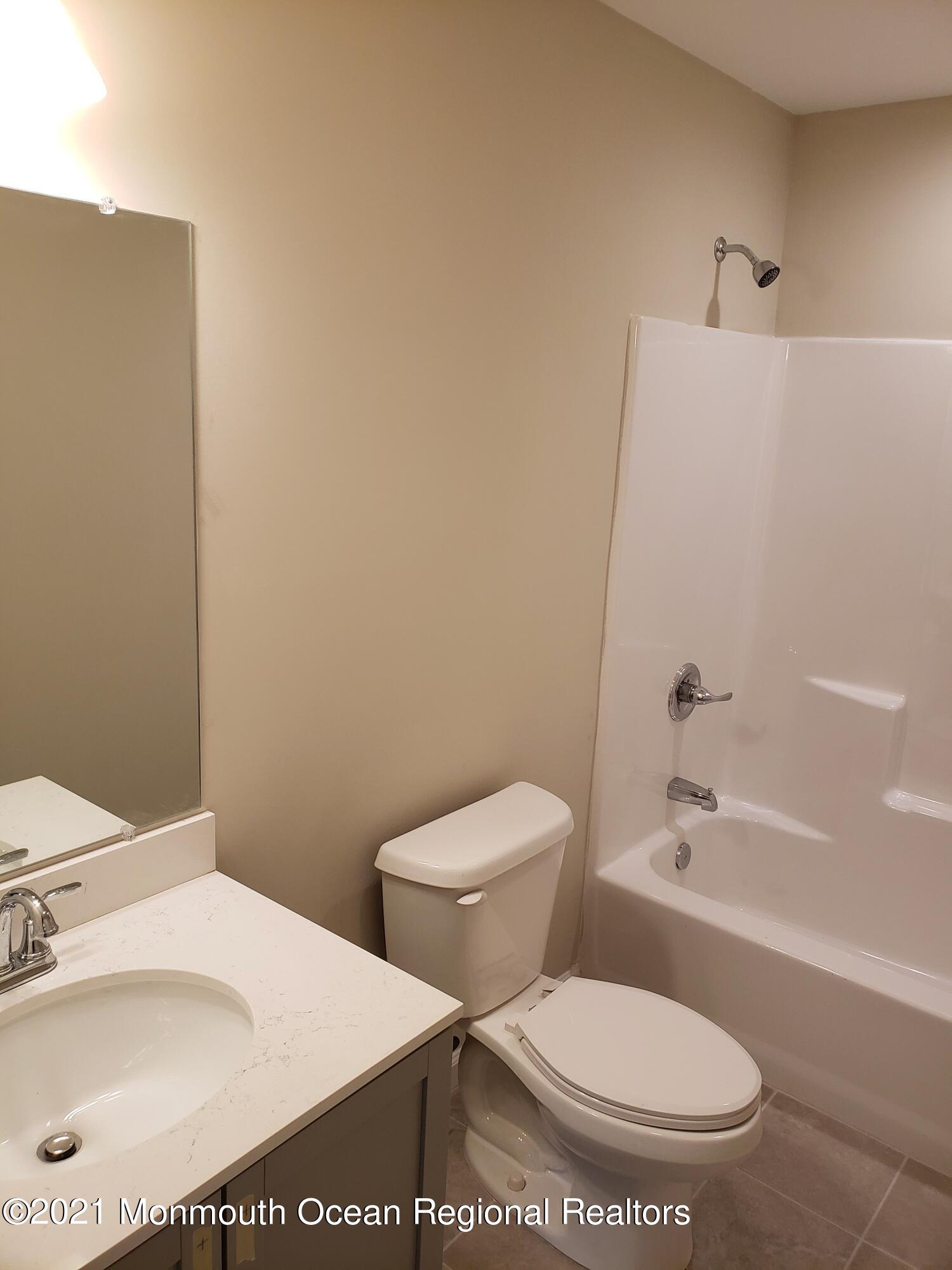154 Jackson Mills Road Freehold, NJ 07728 - Photo 14 of 19 a white toilet sitting next to a bathroom sink