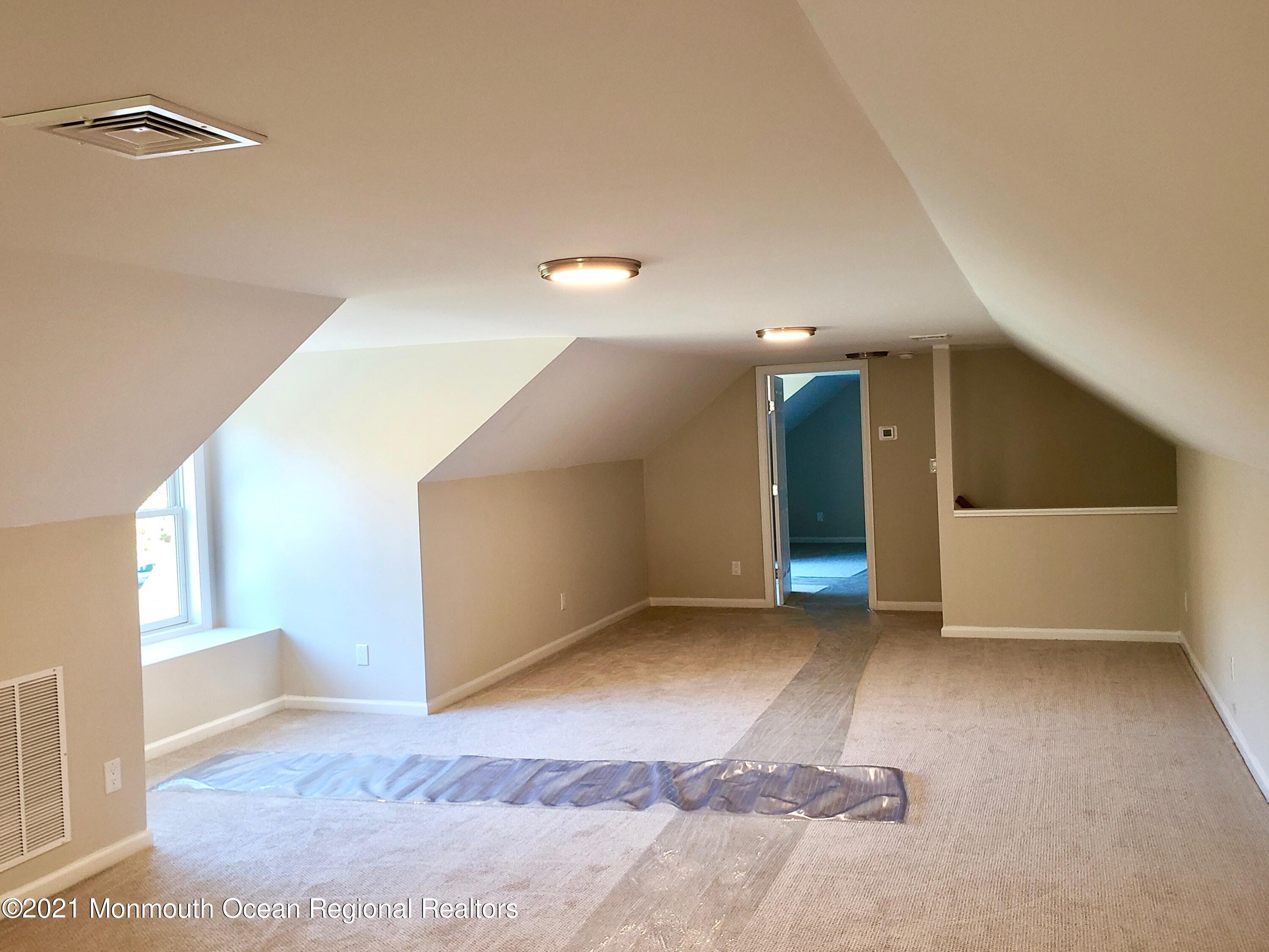 154 Jackson Mills Road Freehold, NJ 07728 - Photo 16 of 19 a view of an empty room with window and stairs