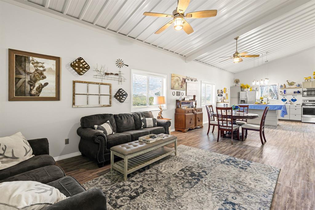 1094 Southwest Sw Cr Saltillo, TX 75478 - Photo 11 of 39 a living room with furniture a wooden floor and chandelier