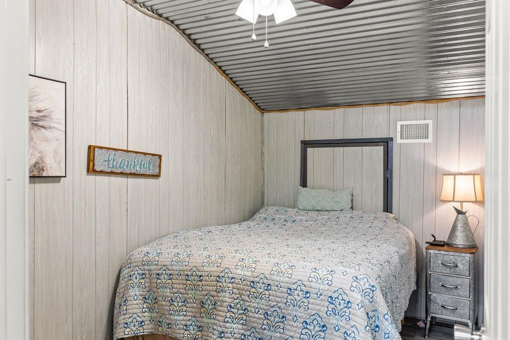 1094 Southwest Sw Cr Saltillo, TX 75478 - Photo 15 of 39 a bedroom with a bed and a night stand