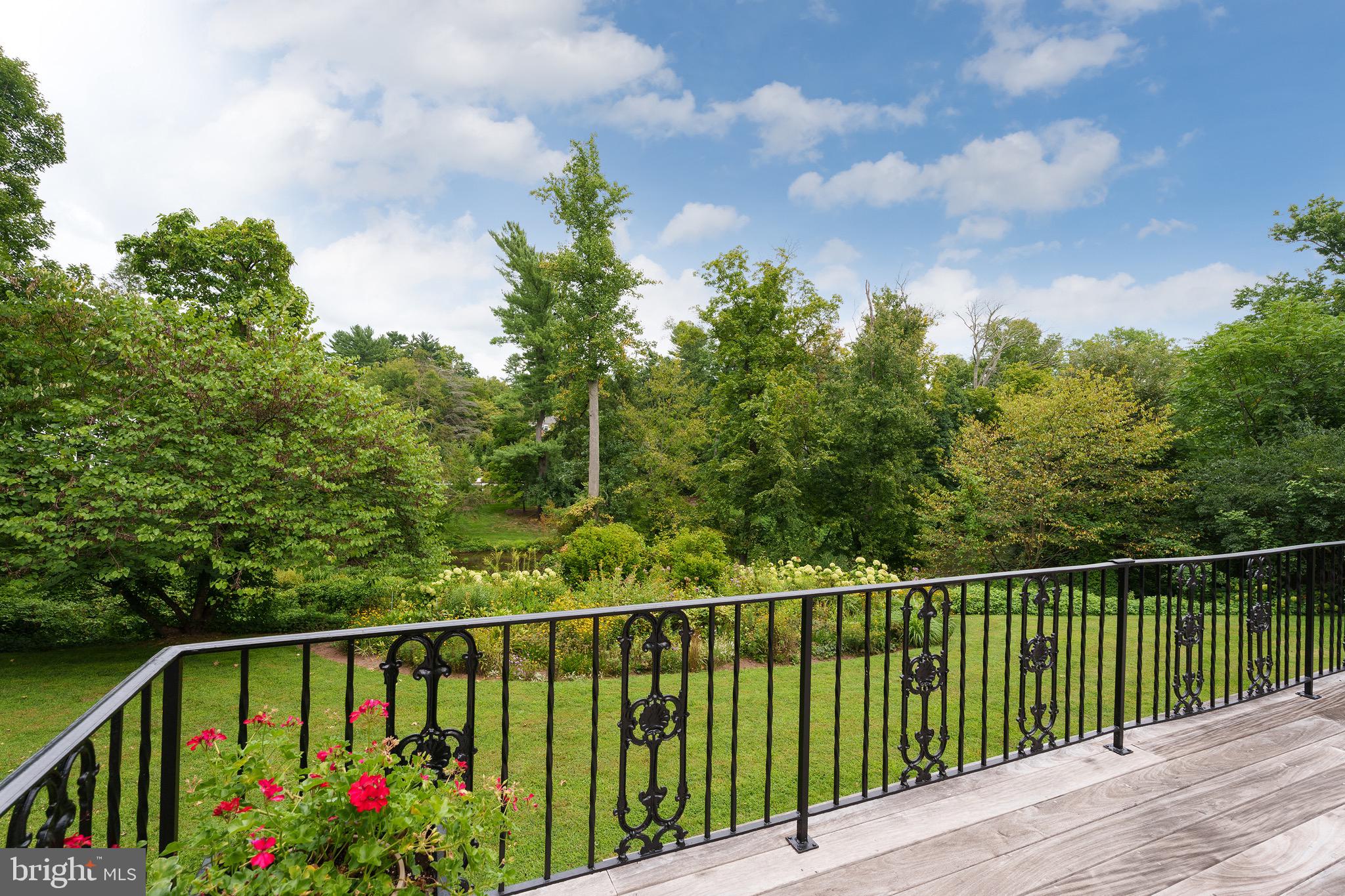 21 Russell Road Princeton, NJ 08540 - Photo 20 of 50 a balcony with wooden floor and trees in the background
