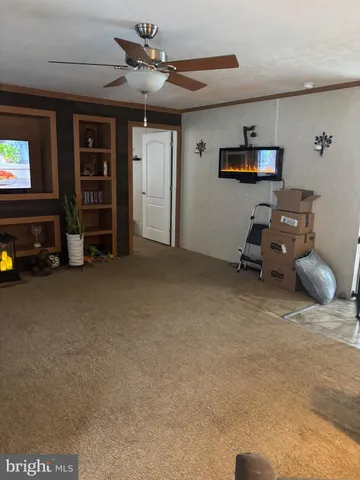 a view of a livingroom with furniture and a flat screen tv