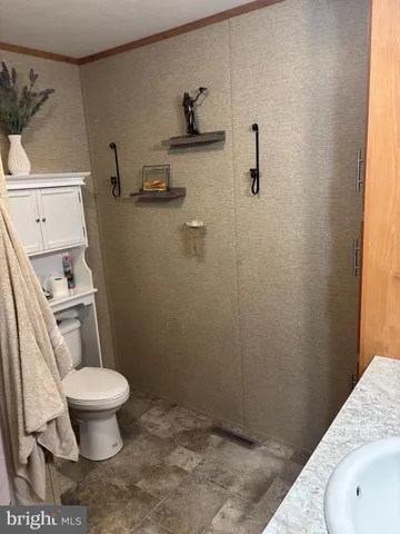 a bathroom with a toilet and a sink