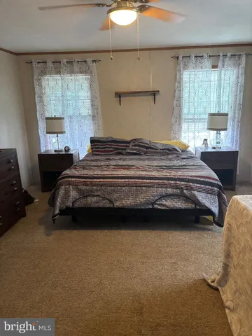 a bedroom with a bed and window