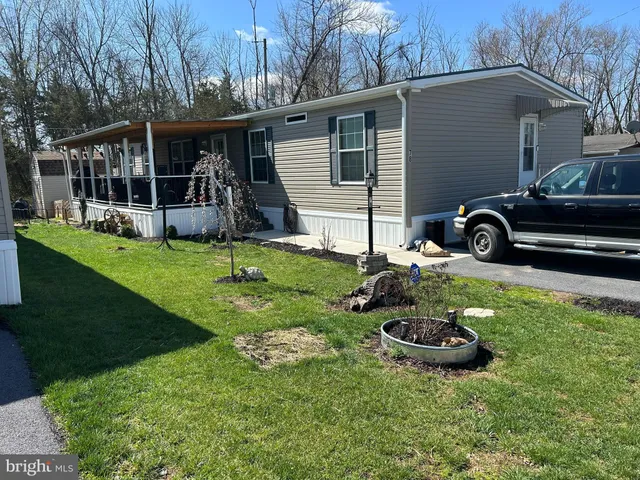 a view of a chair and table in backyard of the house