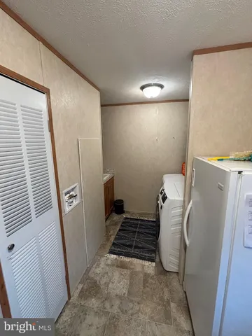 a view of a room with an empty space and a hallway