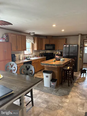 a kitchen with a sink a stove and chairs